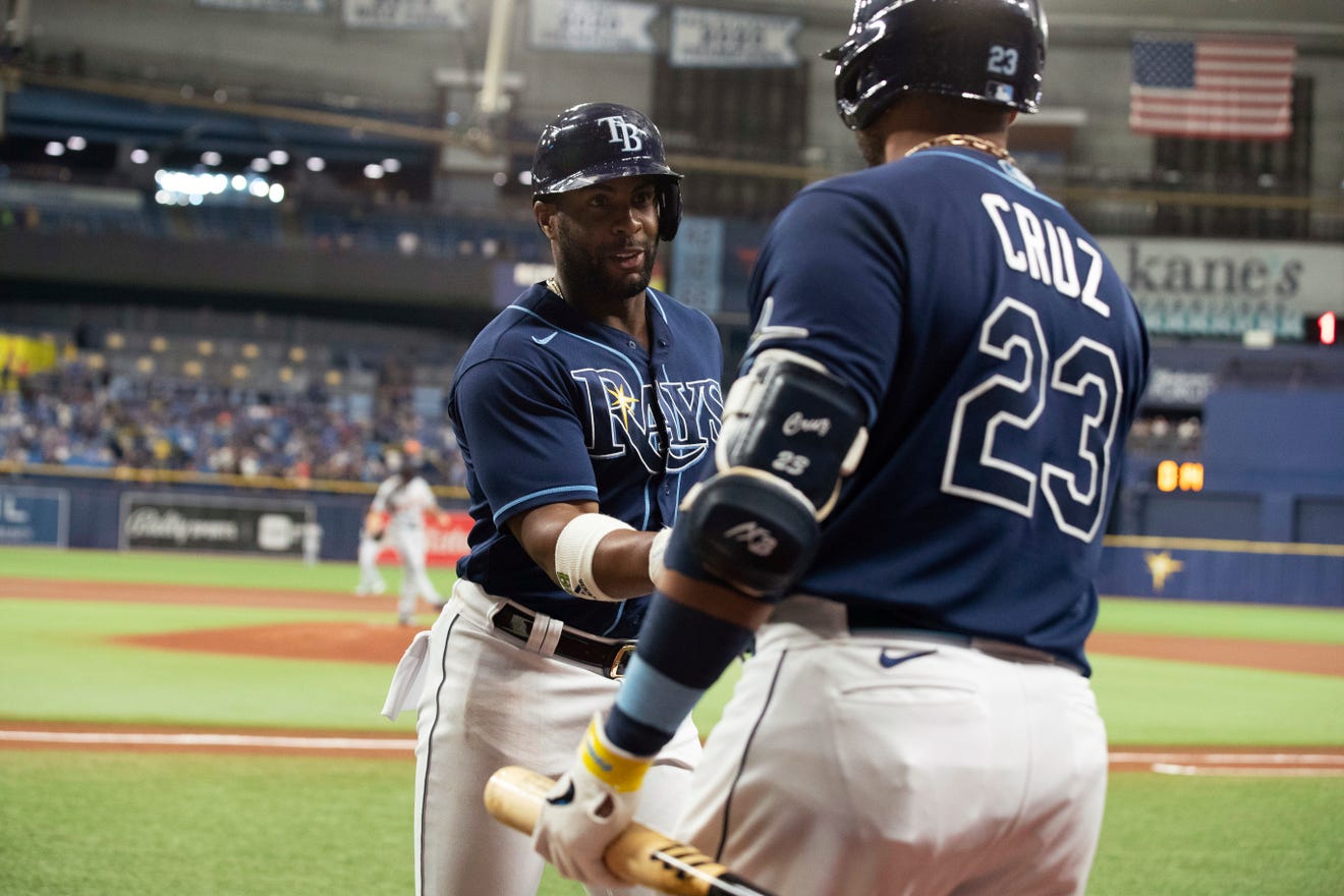 Tampa Bay Rays' Yandy Diaz, left, celebrates with Nelson Cruz after hitting a home run against the Detroit Tigers during the first inning of a baseball game Thursday, Sept. 16, 2021, in St. Petersburg, Fla.