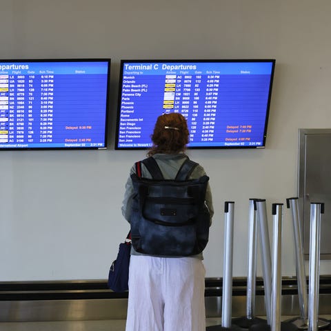 A person looks at a departure schedule in Terminal