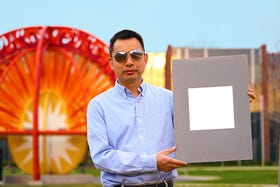Xiulin Ruan, a Purdue University professor of mechanical engineering, holds up his lab's sample of the whitest paint on record.