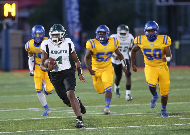 Windsor Forest quarterback Donte Dorman finds some running room against the Beach defense during Friday night's game at Memorial Stadium.