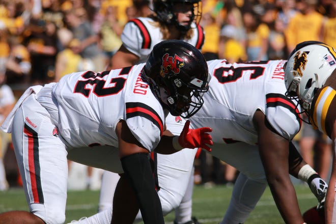 Ball State redshirt sophomore defensive lineman Tavion Woodard (No. 52) lines up against Wyoming's offensive line during their game at Wyoming Saturday, Sept. 18, 2021.