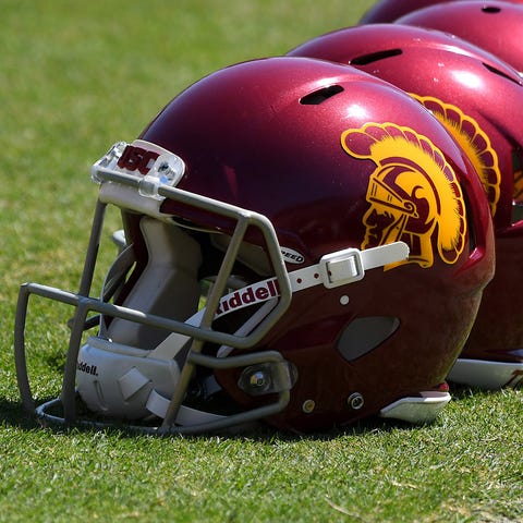 A view of USC football helmets on the field at the