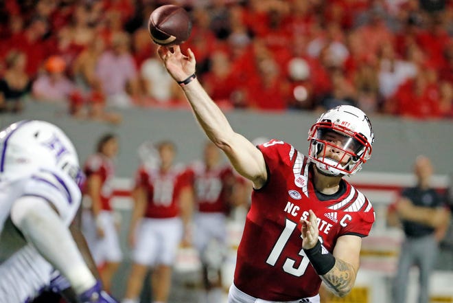 North Carolina State's Devin Leary (13) passes the ball against Furman during the first half of an NCAA college football game in Raleigh, N.C., Saturday, Sept. 18, 2021.