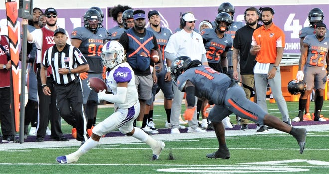 ACU's Kobe Clark, left, looks for running room after making a catch while UTPB's Derrian Forge defends in the first half. ACU beat the Falcons 34-9 on Sept. 18 at Wildcat Stadium.