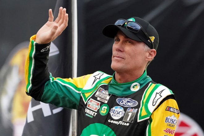 Kevin Harvick waves to fans before a NASCAR Cup Series auto race at Bristol Motor Speedway Saturday, Sept. 18, 2021, in Bristol, Tenn. (AP Photo/Mark Humphrey)
