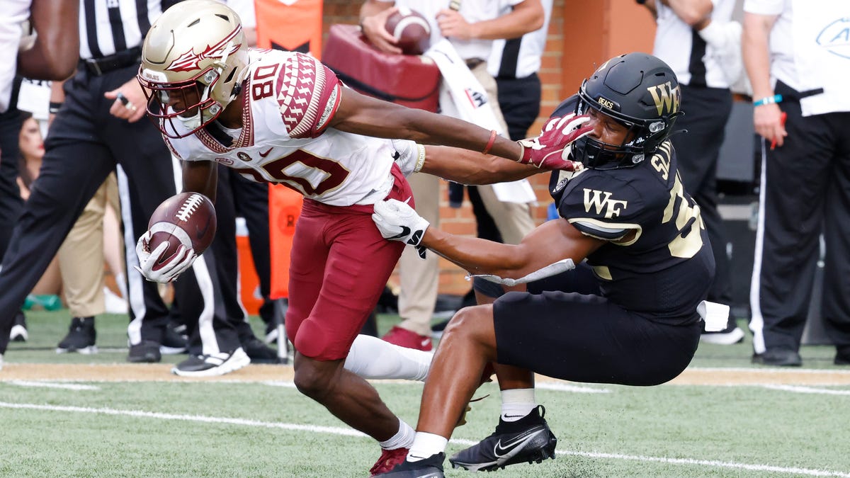 Demon Deacons linebacker Joshua Sosanya tackles Seminoles wide receiver Ontaria Wilson.