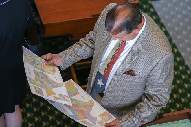 Sen. Eddie Lucio Jr., D-Brownsville, looks over Texas Senate district maps on Monday, the start of the third special legislative session of the year.