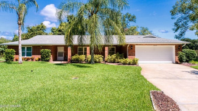 This classic brick home, with great bones, is nestled on a beautifully landscaped, oversized lot in desirable Tomoka Oaks.