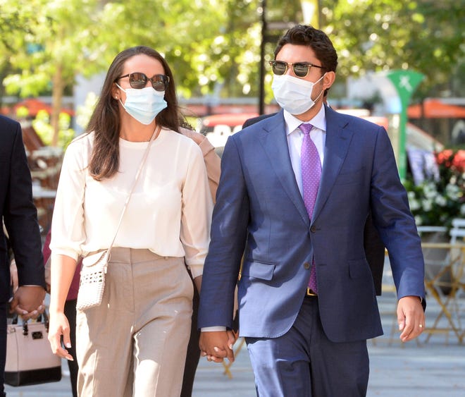 Former Fall River Mayor Jasiel Correia II and his wife, Jen Fernandes, enter John Joseph Moakley Federal Courthouse on Monday.