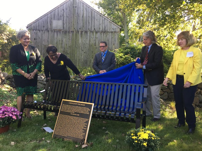 Toni Morrison Society member Cheryl Gooch, society founder Carolyn Denard, society Chairman Craig Stutman, Canterbury First Selectman Chris Lippke and Windham Judicial District State’s Attorney Anne Mahoney unveil the newest Toni Morrison "Bench by the Road" at the Prudence Crandall Museum on Sunday in Canterbury.