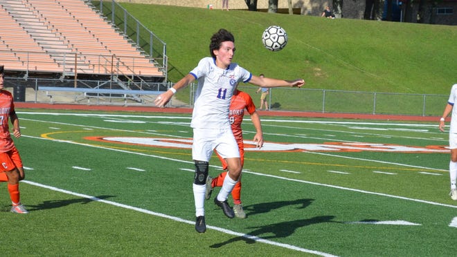 Bugra Kumas (11) of Washington Township gets airborne to bring down a bouncing ball in the midfield during Monday's Olympic Conference American Division meeting with Cherokee.