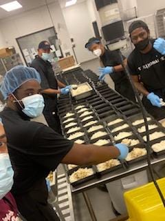 Philabundance staff and Elias Bitar work to package meals for the Afghan refugees.