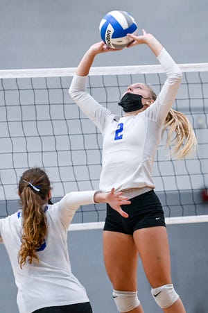 Ionia's Kassidy Casillas sets the ball during the volleyball match against Lansing Catholic on Monday, Sept. 20, 2021, at Lansing Catholic High School. The Cougars won the match 3 sets to 1.