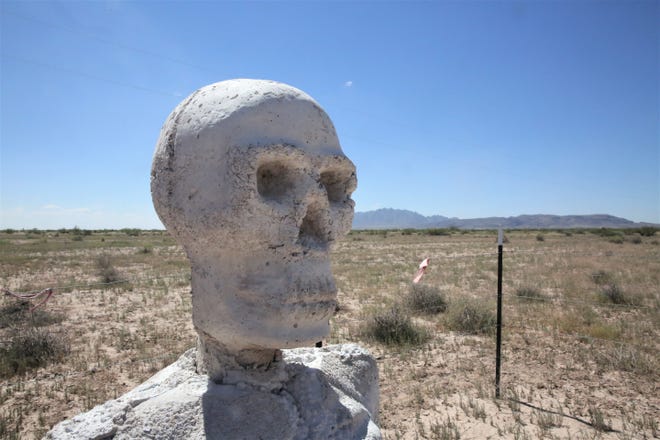 A statue that is part of an open-space art installation entitled "Siddhartha is Dead" sits on private land in Luna County, New Mexico with the Florida Mountains in the background on Monday, Sept. 20, 2021.