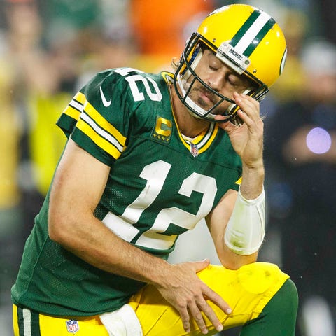 Packers quarterback Aaron Rodgers reacts after a p