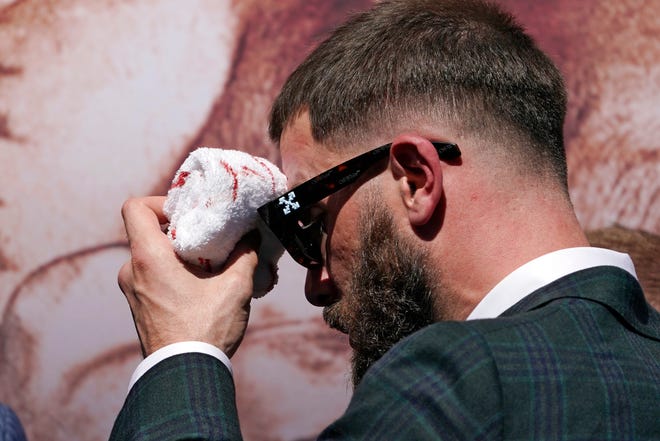 Undefeated IBF super middleweight champion Caleb Plant wipes his head after being cut off in a scuffle with unified WBC / WBO / WBA super middleweight champion Canelo Alvarez.