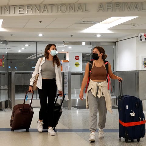 Travelers arrive at Miami International Airport on