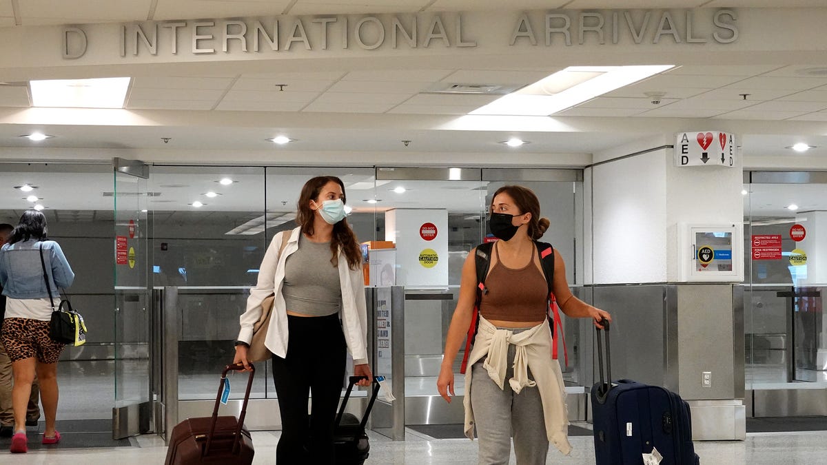 Travelers arrive at Miami International Airport on September 20, 2021.