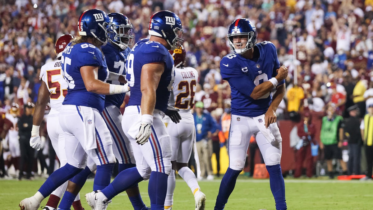 Daniel Jones of the New York Giants celebrates with teammates after rushing for a touchdown during the first quarter against the Washington Football Team at FedExField on September 16, 2021 in Landover, Maryland.