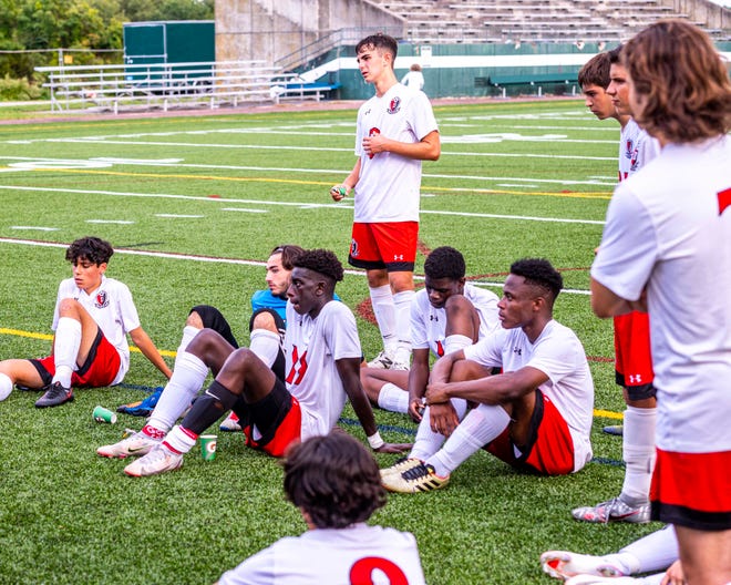 Durfee's Soccer team listens to corrections from the coach at half time.