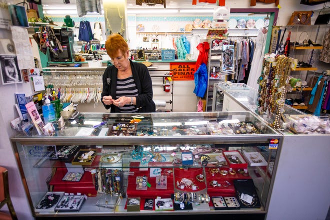 Joan Ross prepares items for a customer Wednesday, Sept. 22, 2021, at Miami Village Consignment Shoppe in South Bend.