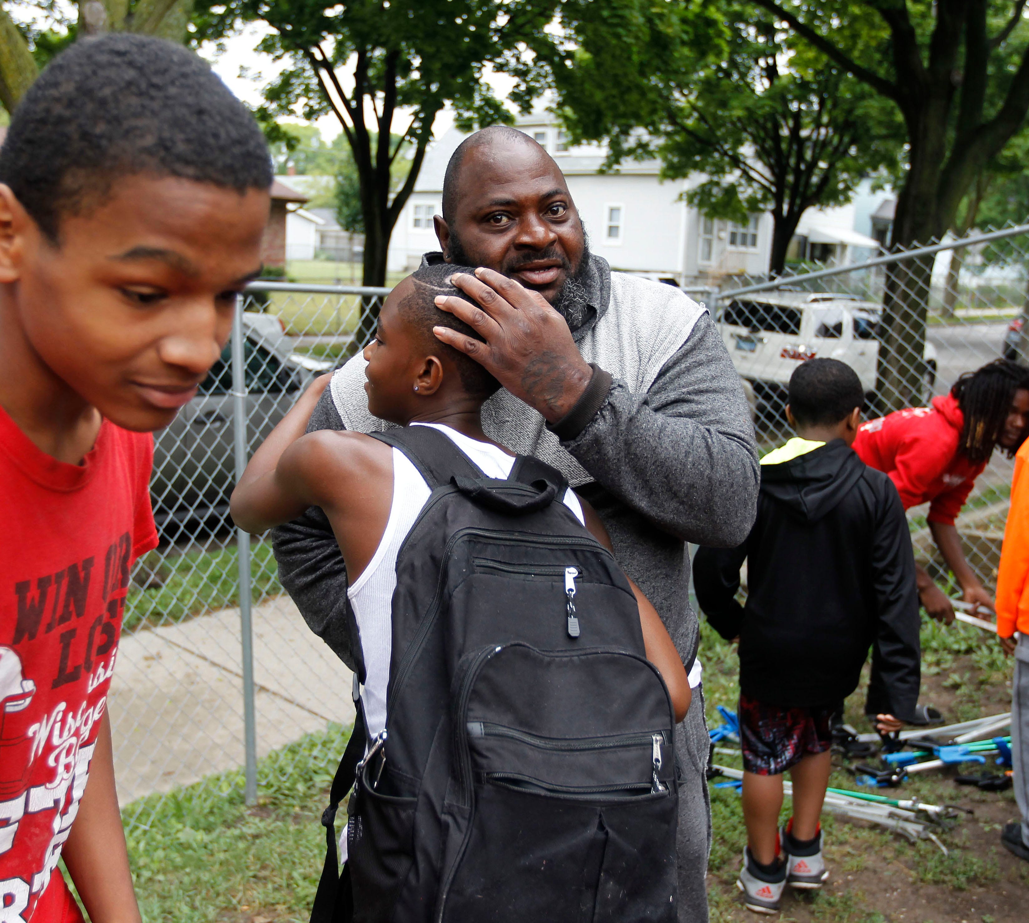 June Thomas greets a youth in 2018 at "We Got This," a program that mentors male youth through gardening and life lessons in Milwaukee.