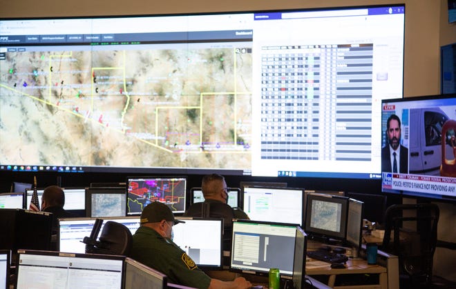 Border Patrol agents work in the Arizona Air Coordination Center in Tucson. The center coordinates air assets in support of agents on the ground conducting border enforcement.