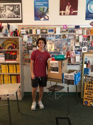 Gustavo Trope Mayer, a 16-year-old junior at Riverview High School, is one of the members of the Jewish Federation of Sarasota-Manatee Shapiro Teen Engagement Program spearheading a collection of supplies for Afghan refugees. Here, he poses with a collection box at school.