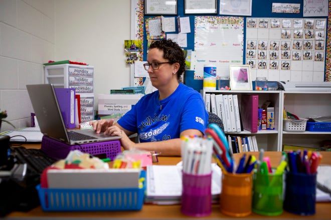 Second grade teacher Suzi Huffman watches her students on the computer at her desk inside her classroom at Hillview Elementary in Newark, Ohio on September 22, 2021. Huffman has been teaching online this week because all of the students in her class are in quarantine because one of her students tested positive for COVID-19.