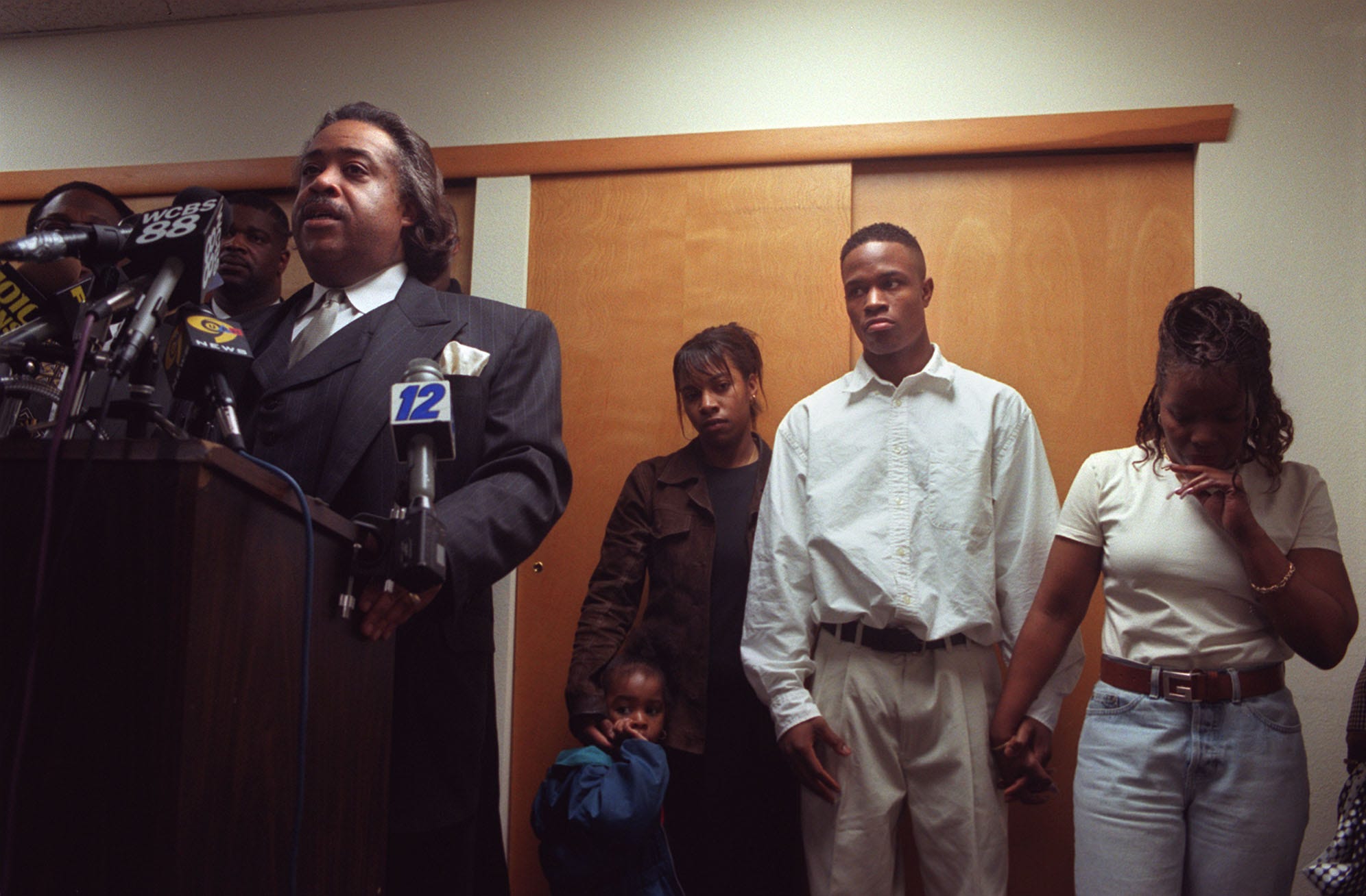 Keshon Lamonte Moore, 22, stands with family at his sides as Rev. Al Sharpton speaks during a press conference at Abyssinian Baptist Church, in Newark, Sunday, April 26, 1998.