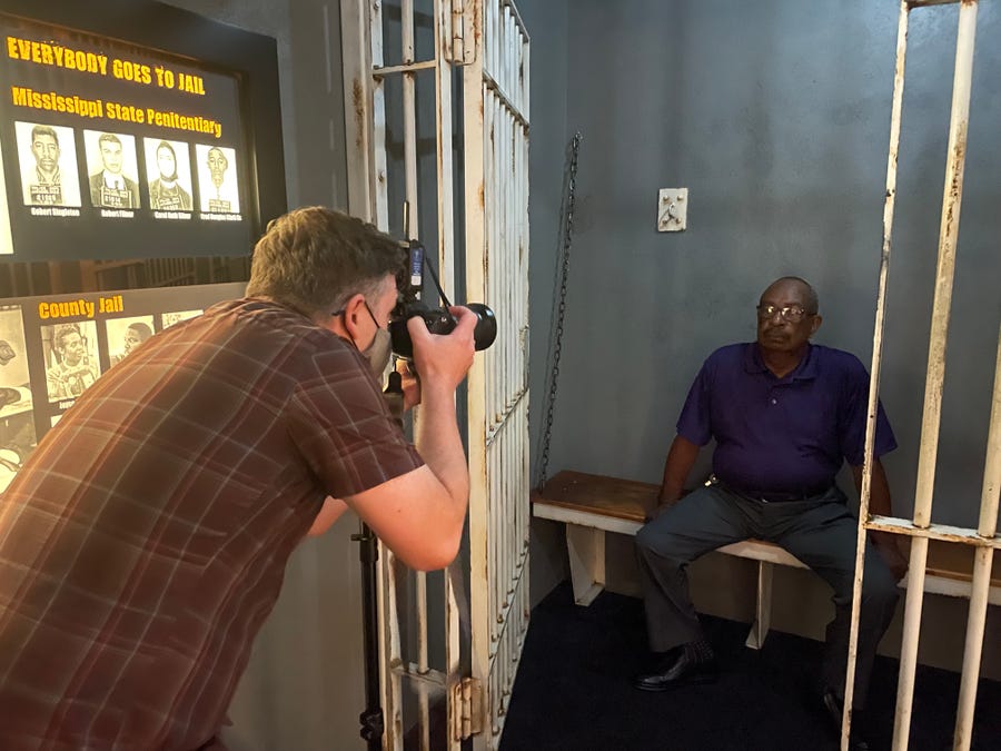 USA Today journalist Jasper Colt photographs Hezekiah Watkins as he sits for a portrait in a recreated jail cell in the Mississippi Civil Rights Museum. 