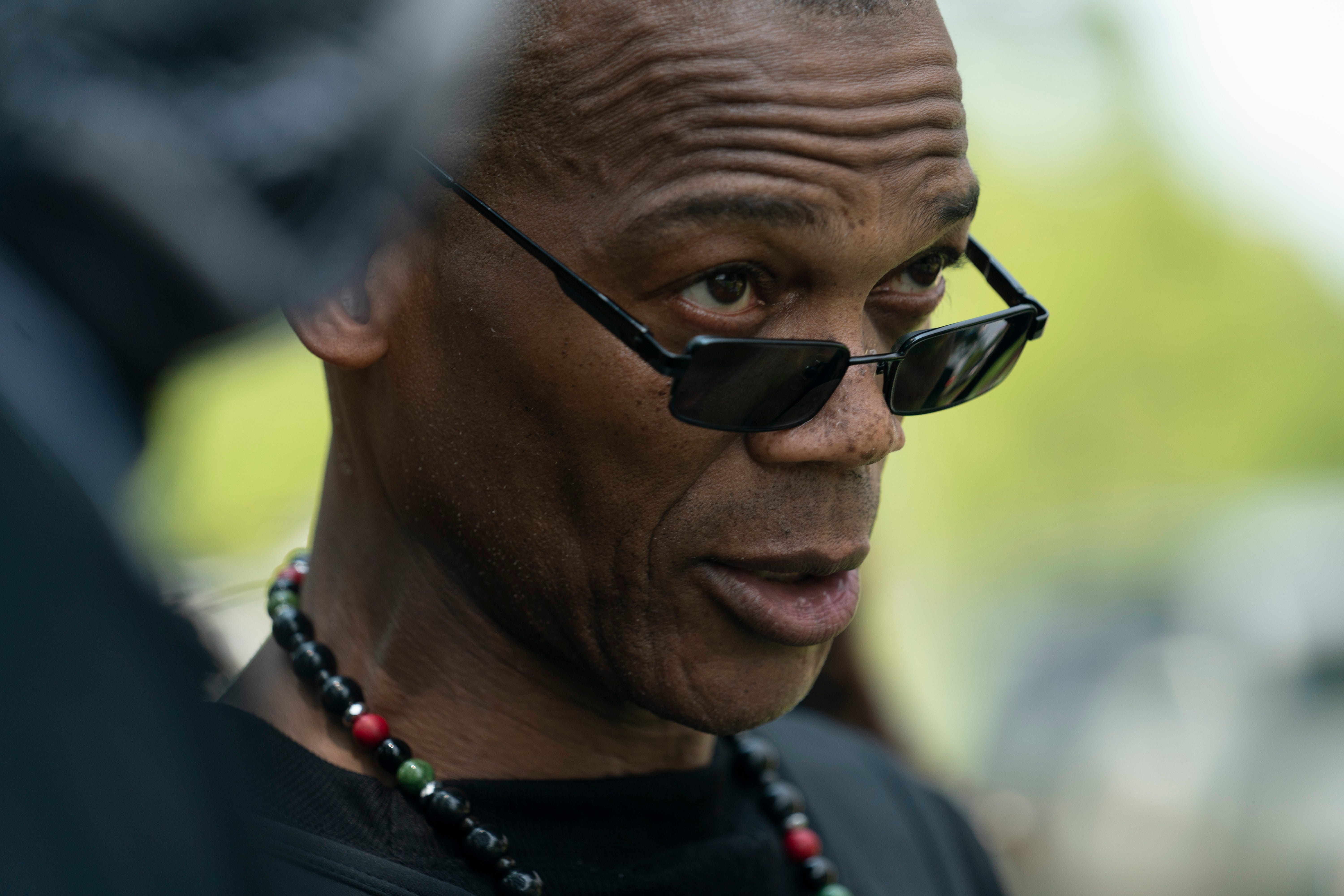 John Fitzgerald Johnson, who goes by Grandmaster Jay, greets members and supporters of NFAC during a "Feed the People" event July 24, 2021, at Chickasaw Park in Louisville.