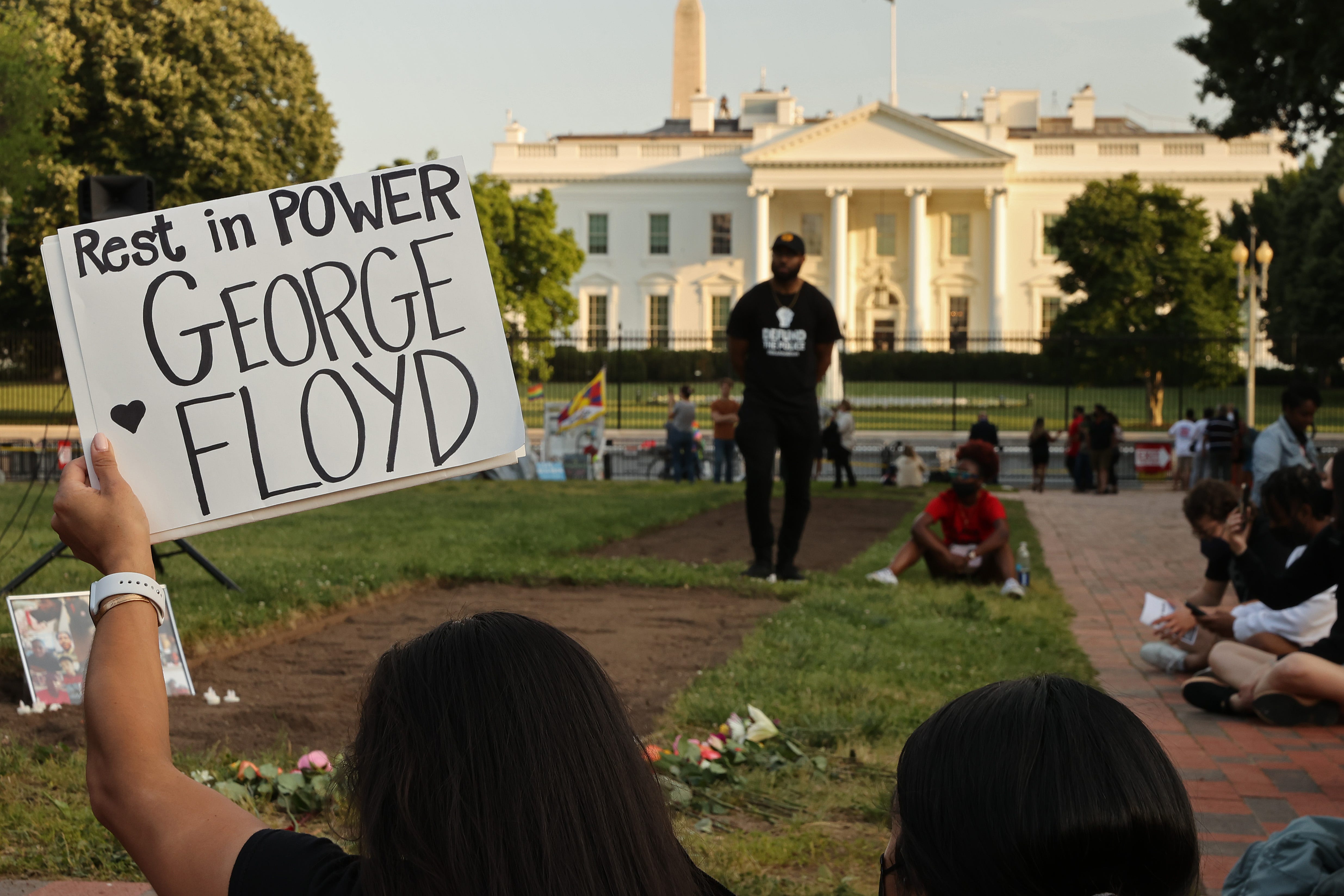 A small group of people gather for a vigil on the one-year anniversary of George Floyd's murder in Lafayette Square near the White House on May 25, 2021.