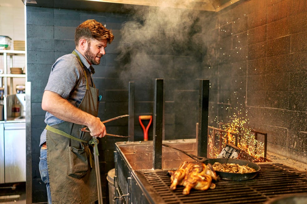 Executive chef Jeffrey Hundelt works the open grill at Summer House on Music Lane.