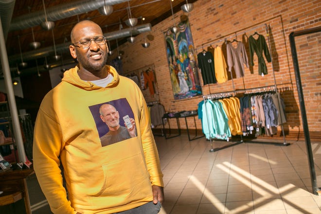 O.D. Patton III, who co-owns Danetrik's clothing store with his wife Faith, poses for a portrait amongst the merchandise racks on Thursday, Sept. 23, 2021, at the East State Street shop in Rockford. The shop sells men's and women's clothing and accessories, including brands by the Pattons.