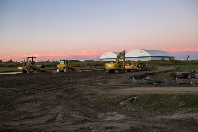 Construction equipment is parked for the night Thursday, Sept. 23, 2021, inside the ecologically sensitive Bell Bowl Prairie on Cessna Drive at Chicago Rockford International Airport in Rockford.