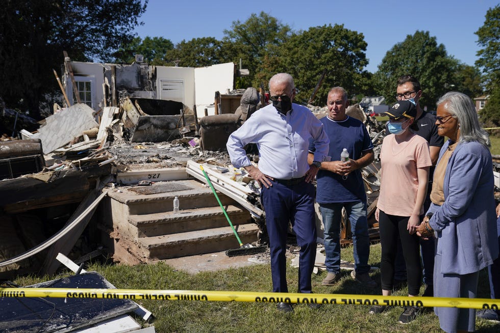 President Joe Biden tours a neighborhood impacted by Hurricane Ida, Tuesday, Sept. 7, 2021, in Manville. Rep. Bonnie Watson Coleman, D-N.J., looks on at right.