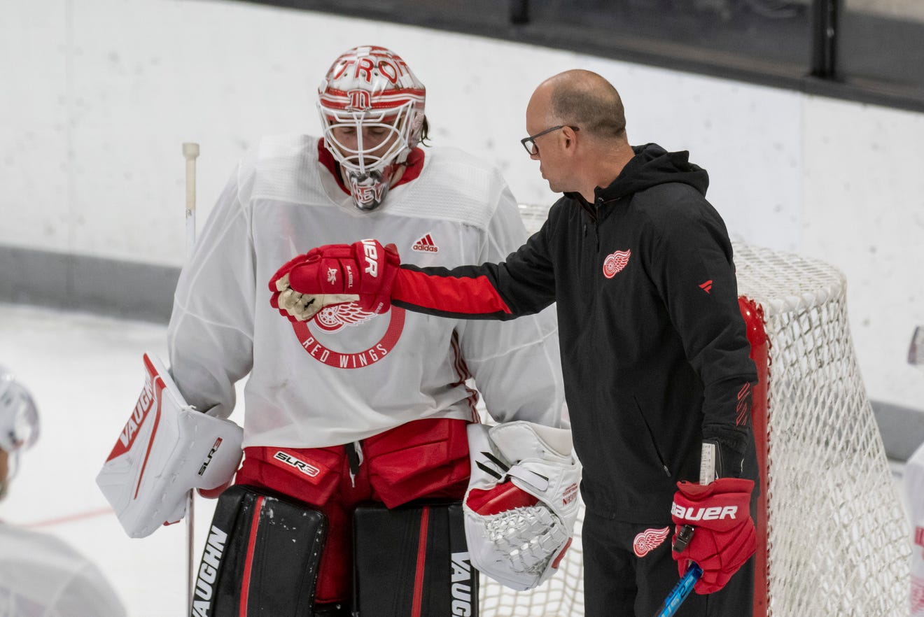 Goaltender Alex Nedeljkovic chats with head coach Jeff Blashill during the Red Wingsu2019 training camp at Centre Ice Arena in Traverse City on Friday.