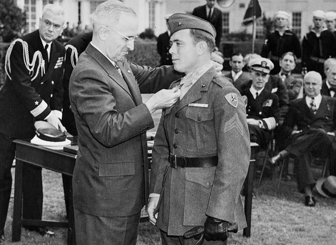 Hershel “Woody” Williams receiving the Medal of Honor from President Truman.