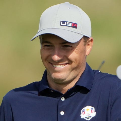 Jordan Spieth reacts to seeing his shot after walk