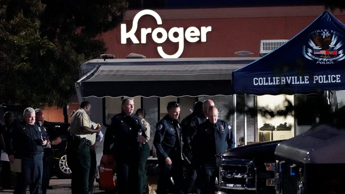 Law enforcement personnel work in front of a Kroger grocery store as an investigation goes into the night following a shooting earlier in the day on Thursday, Sept. 23, 2021, in Collierville, Tenn.