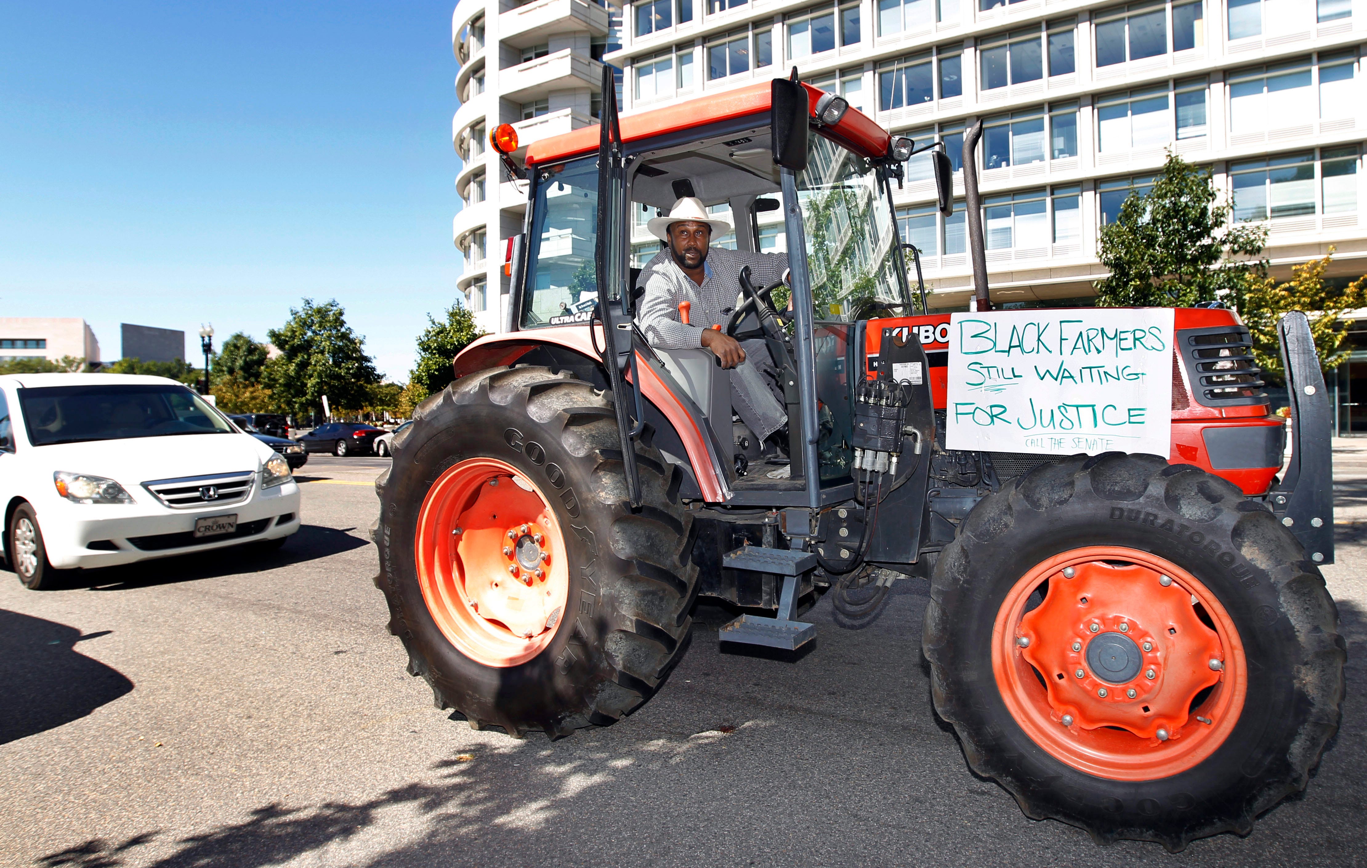 Black farmer John Boyd drives his tractor "Justice" near the the Capitol in Washington, Monday, Sept. 20, 2010. Boyd drove from Virginia to Capitol Hill calling on lawmakers on a stand alone vote to pass black farmers bill.