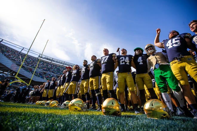 Notre Dame players line up for the alma mater during the Notre Dame vs. Wisconsin NCAA football game Saturday, Sept. 25, 2021 at Soldier Field in Chicago. 