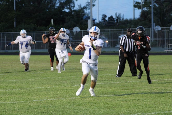 Wellington quarterback Ryan Anthony (1) carrying the ball into the endzone in a game against John I. Leonard on Sept. 24, 2021. He finished with a rushing score for the Wolverines in a 49-0 win.