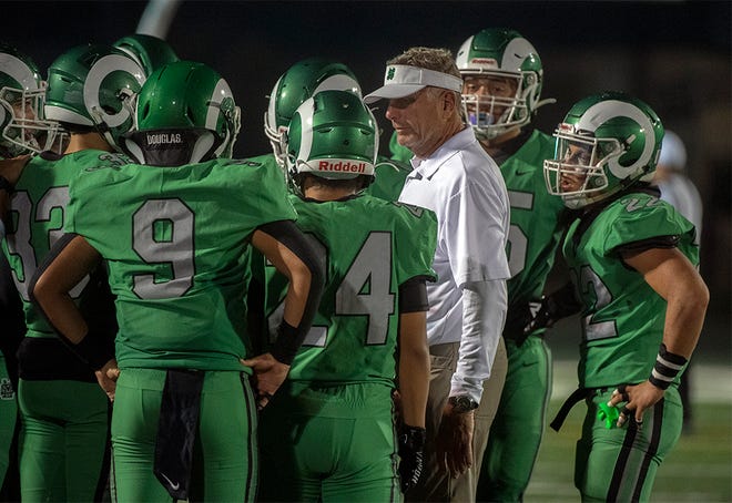 St. Mary's head coach Tony Franks talks to his team before kick off in a college football game against Cardinal Newman September 24 at St. Mary's Sanguinetti Field in Stockton.