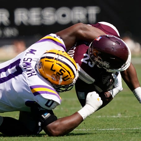 LSU defensive lineman Maason Smith (0) tackles Mississippi State running back Dillon Johnson (23) during the first half of an NCAA college football game, Saturday, Sept. 25, 2021, in Starkville, Miss. LSU won 25-23. (AP Photo/Rogelio V. Solis)