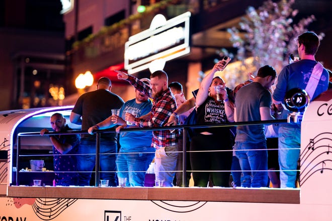 Customers drink on a party bus on Broadway in Nashville, Tenn., Friday, Sept. 24, 2021.