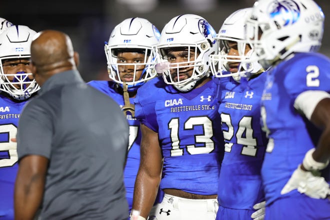 Linebacker Gerald Simpson and teammates listen to their coach during the Fayetteville State University vs. Virginia State University football game on Sept. 25, 2021, at Jeralds Stadium in Fayetteville.
