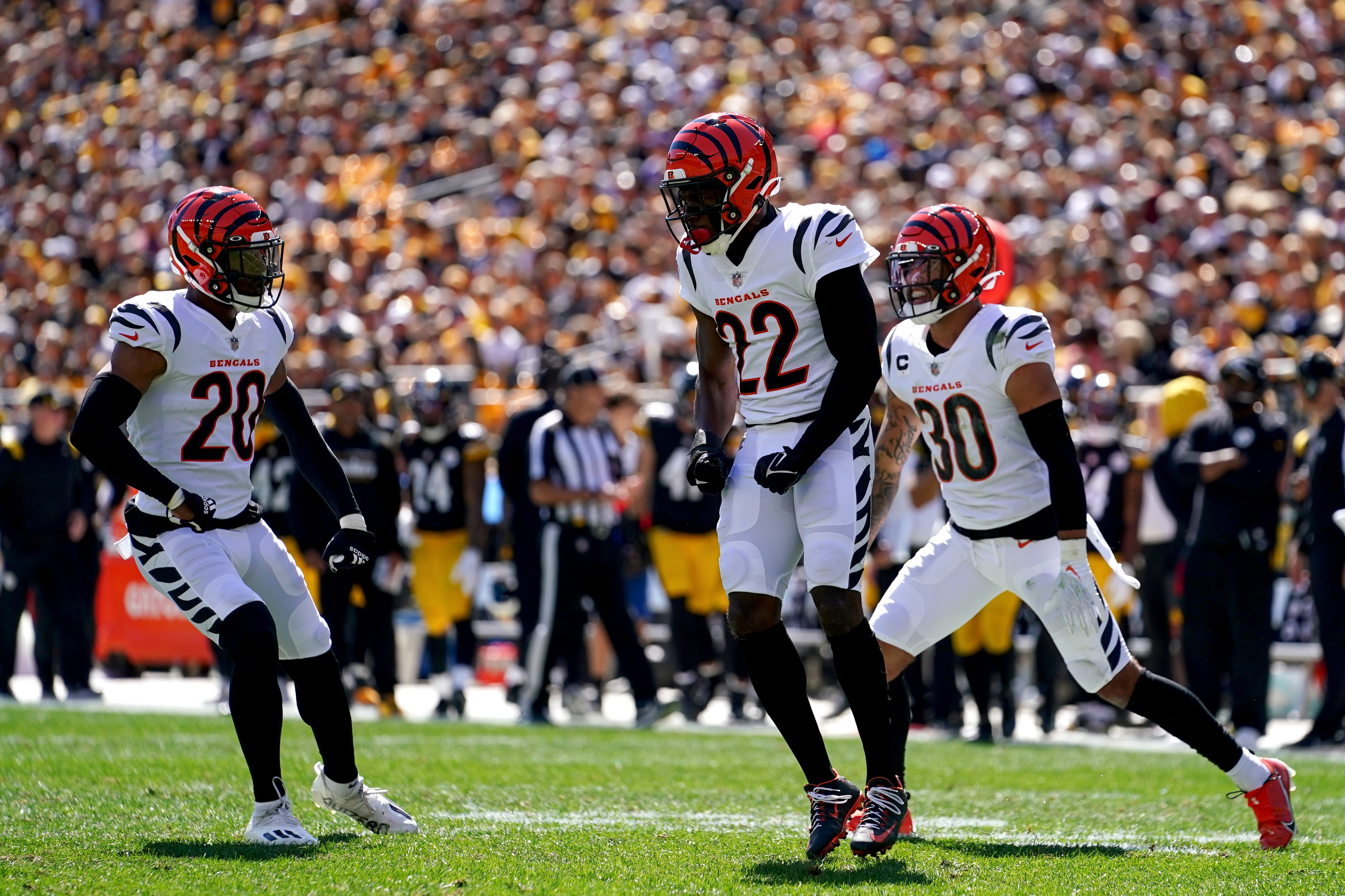 Cincinnati Bengals cornerback Chidobe Awuzie (22), center celebrates a tackle for loss of Pittsburgh Steelers wide receiver Chase Claypool (11) (not pictured) in the first quarter during a Week 3 NFL football game against the Pittsburgh Steelers, Sunday, Sept. 26, 2021, at Heinz Field in Pittsburgh.