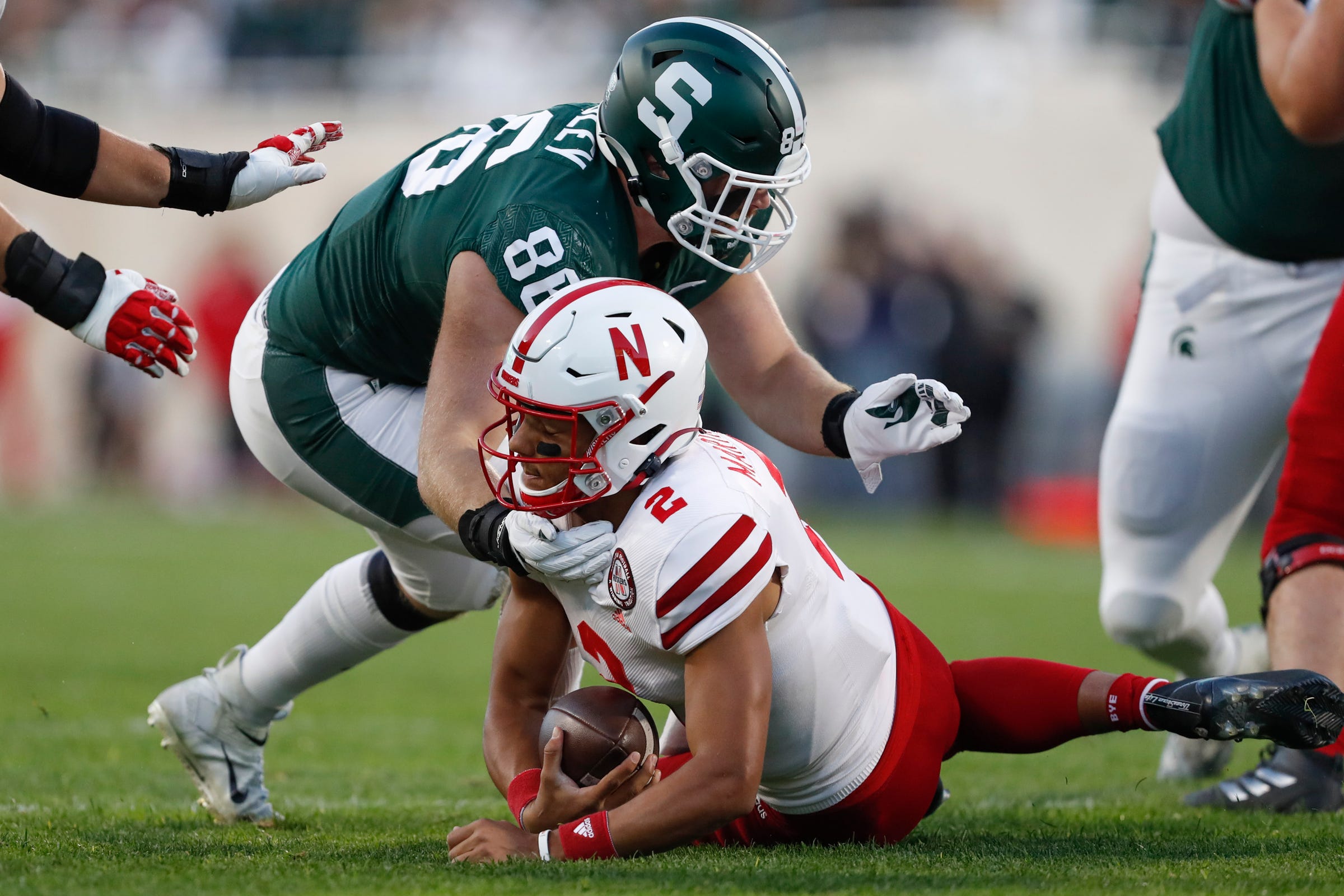 Nebraska quarterback Adrian Martinez goes down in front of Michigan State defensive end Drew Beesley during the first quarter on Saturday, Sept. 25, 2021, in East Lansing.